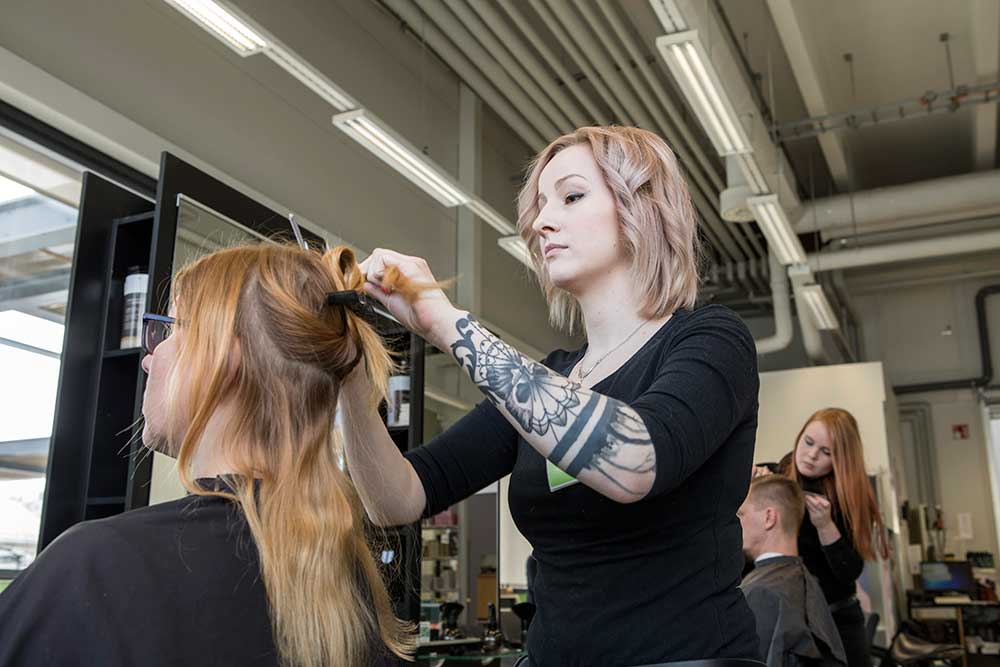Rimmaamo Rasti | naispuolinen kampaaja tekee kampausta naisasiakkaalle